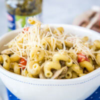 A bowl of pasta sits on a plate