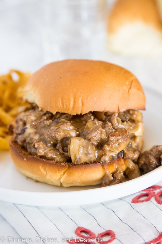 A sandwich sitting on top of a paper plate, with Dinner and Cheesesteak