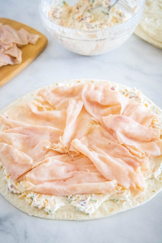 adding sliced turkey over cream cheese mixture