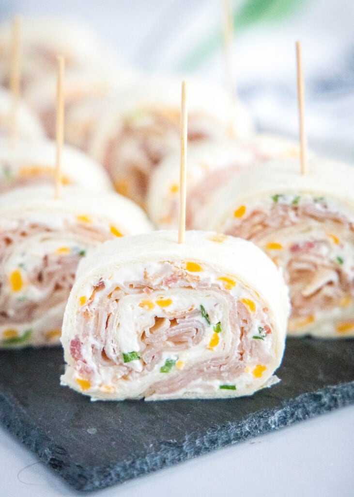pinwheel sandwich arranged on a board with toothpicks