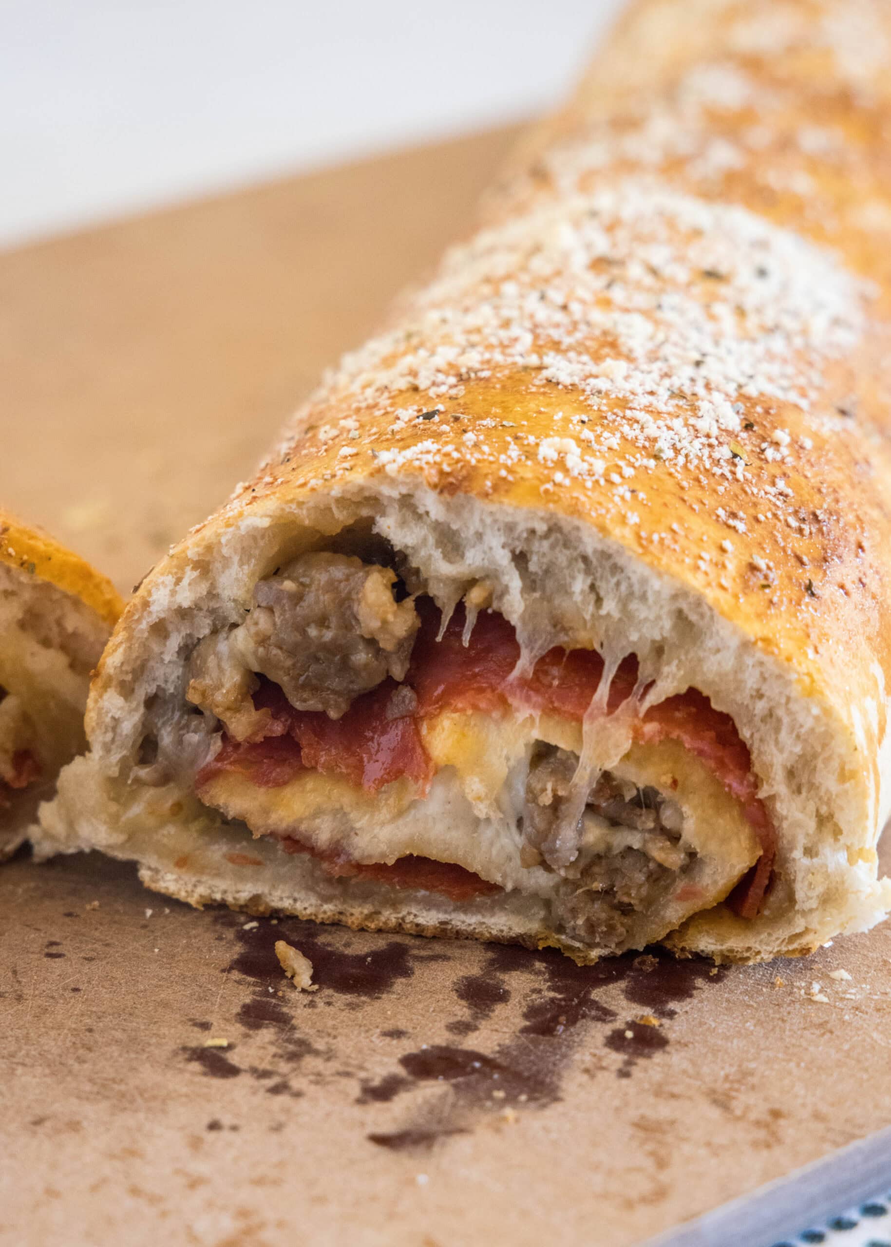 A pizza bread roll with a slice missing from the end.