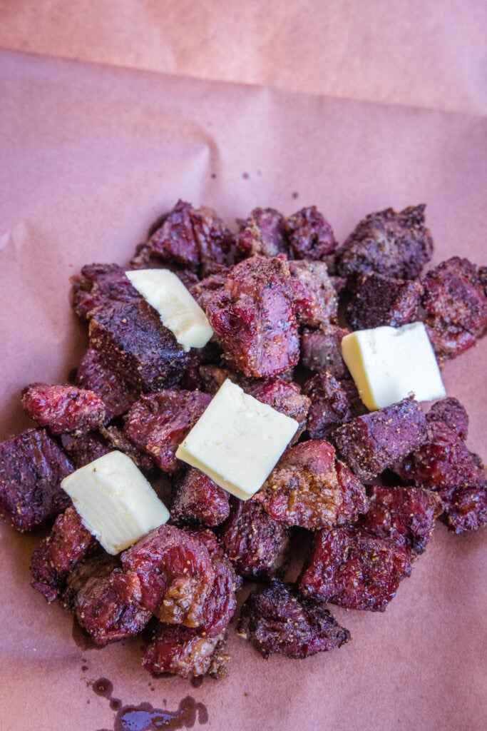 burnt ends getting wrapped in butcher paper with butter