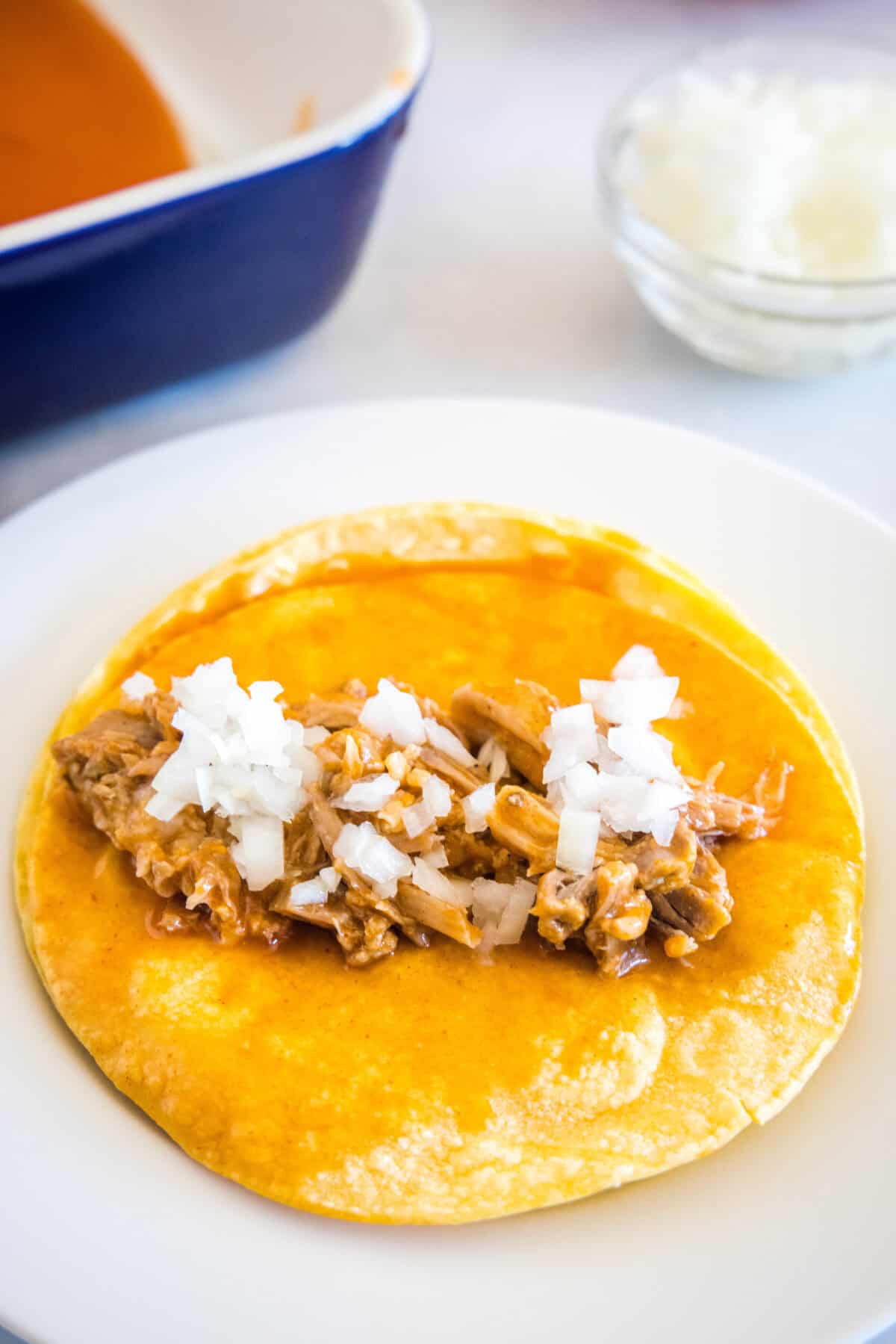 pork and onions on a corn tortilla