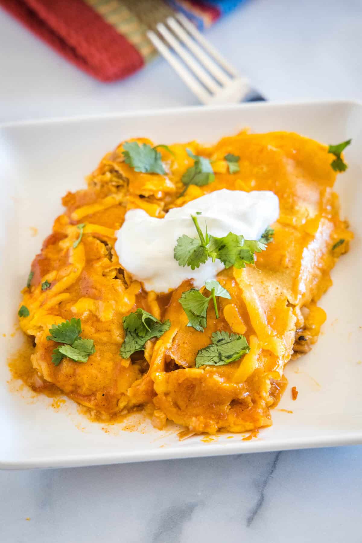 Pork Enchiladas | Dinners, Dishes, and Desserts enchiladas on a plate topped with sour cream