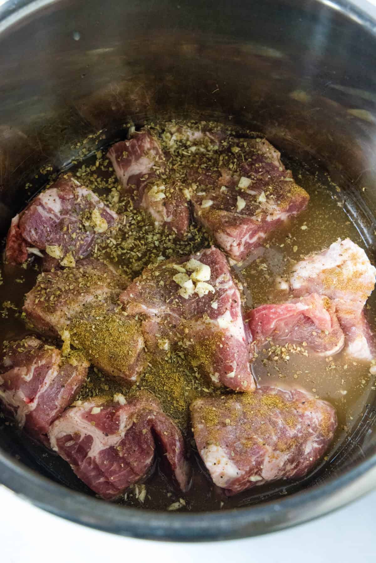 adding ingredients to instant pot for pork tacos