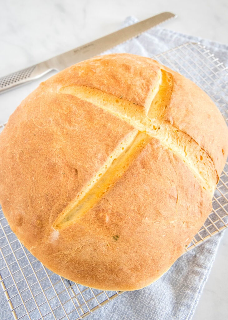 loaf of baked potato bread on cooling rack