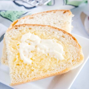 cropped close up of sliced of bread with butter
