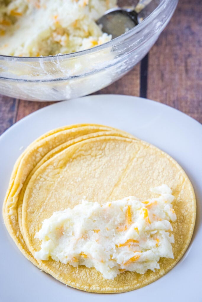 filling tortillas with mashed potatoes
