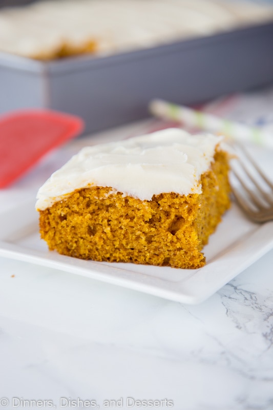 A piece of cake on a plate, with Pumpkin and Cream cheese
