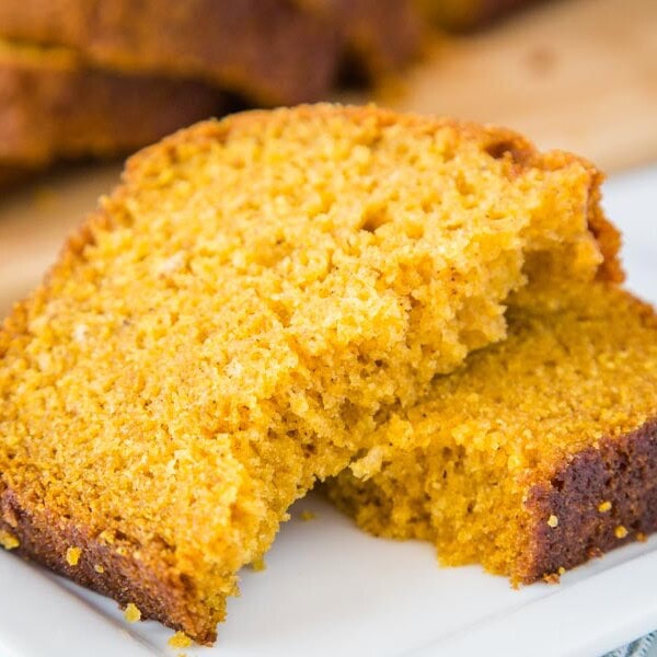 A close up of a slice of  punpkin bread on a plate