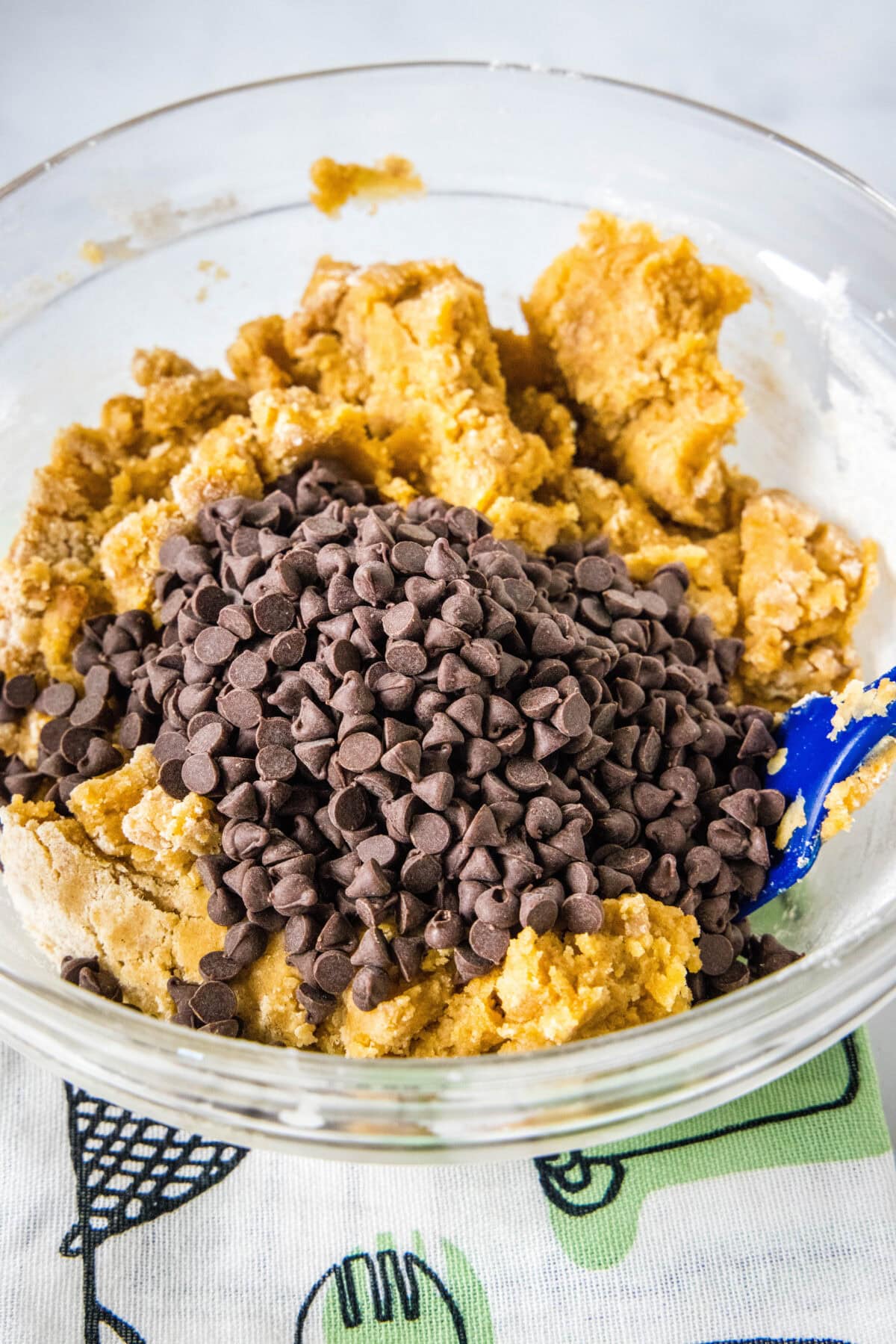 adding chocolate chips to pumpkin cookie dough