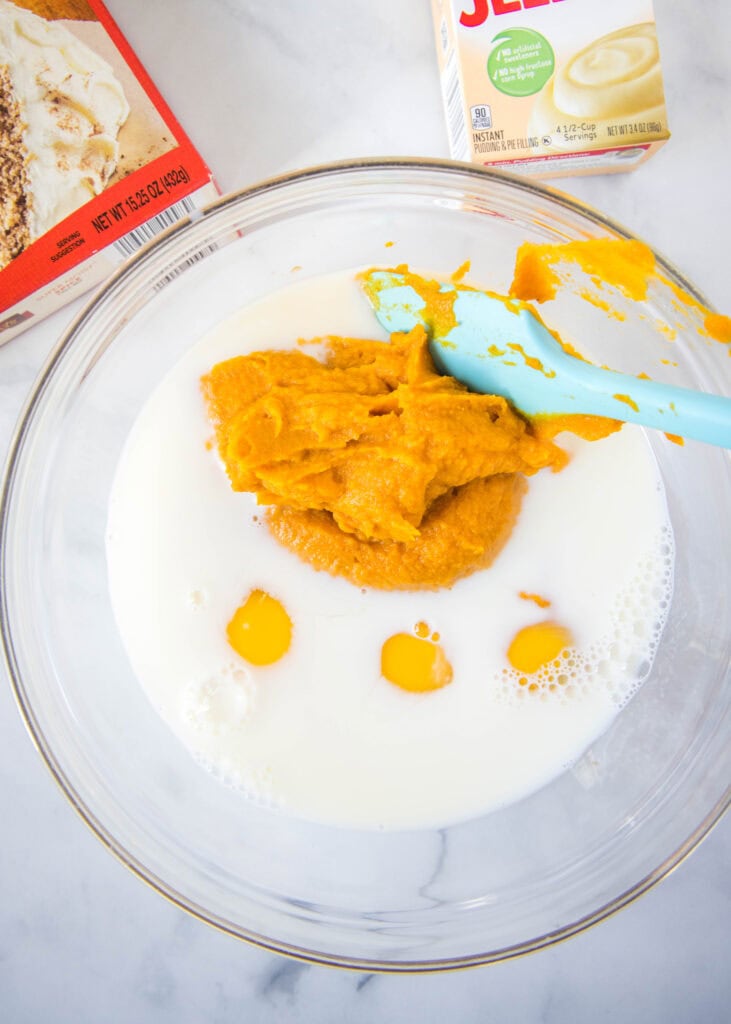 pumpkin, milk and eggs in a mixing bowl