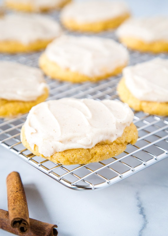 frosted pumpkin sugar cookies on cooling wrack