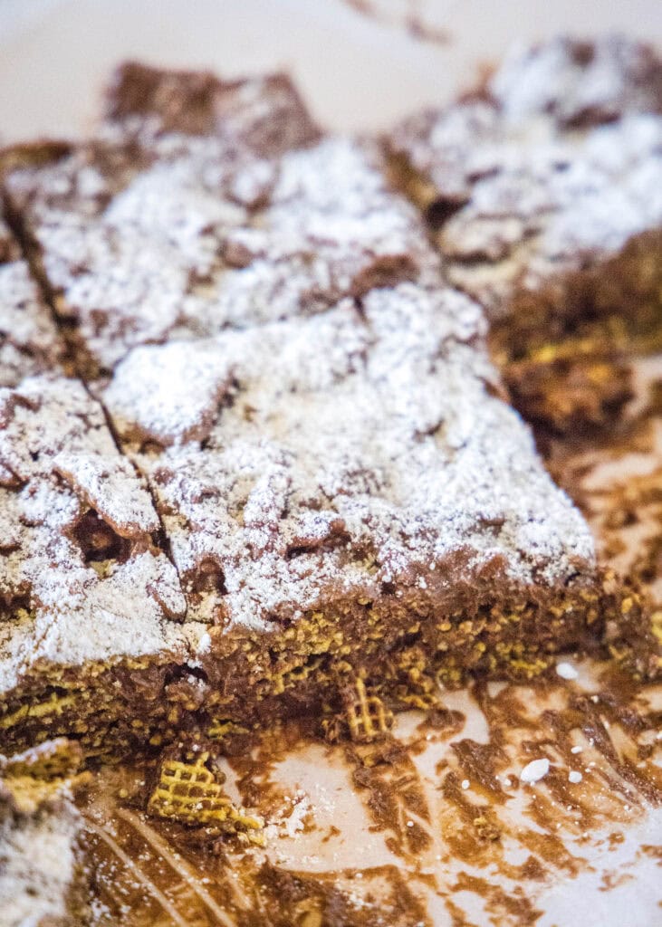 puppy chow bars on parchment paper
