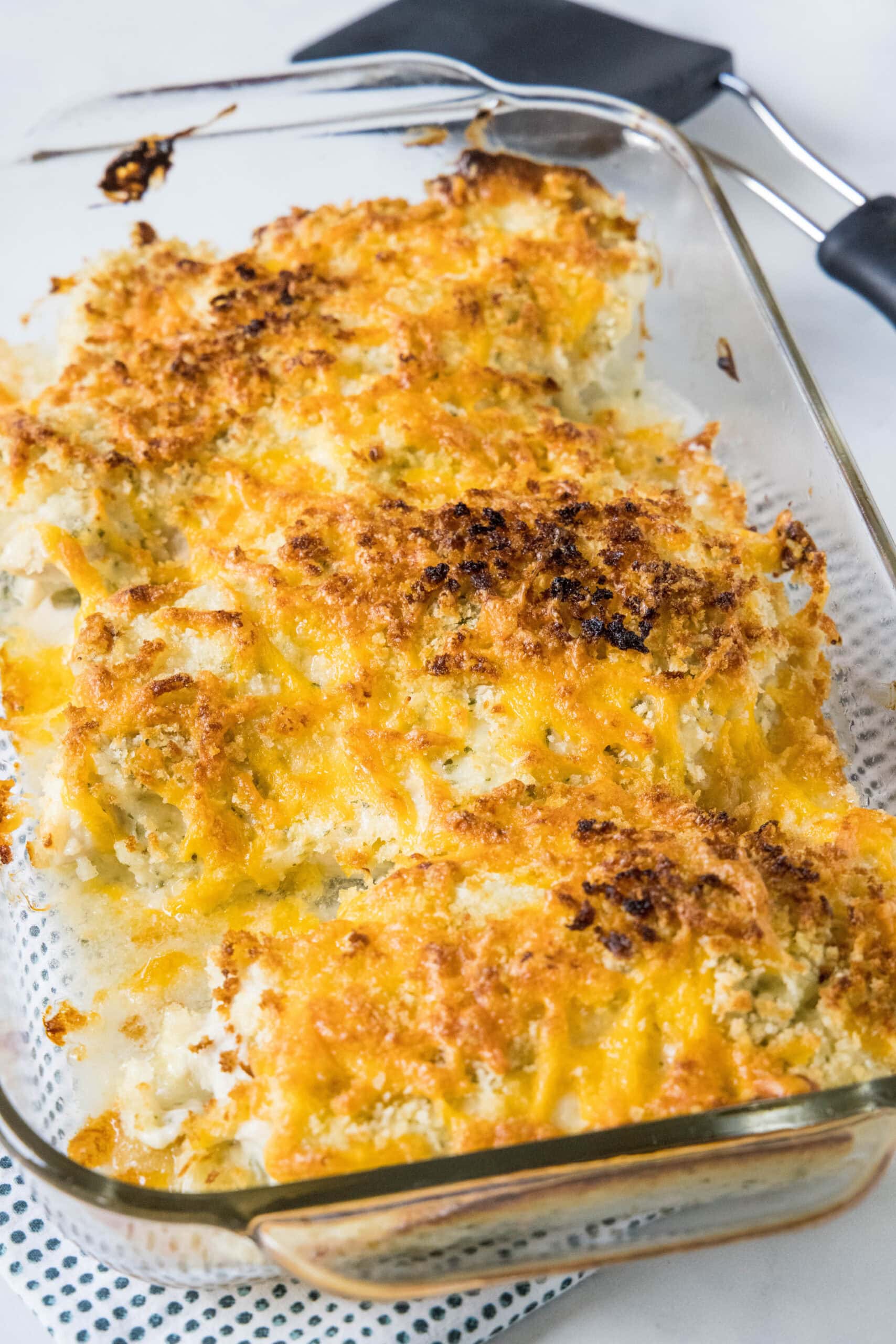 Baked ranch chicken in a glass casserole dish.