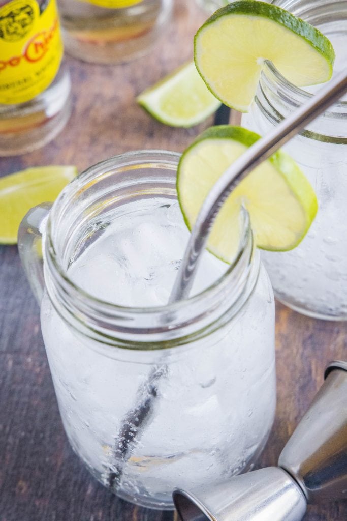 glass of tequila and soda with a straw
