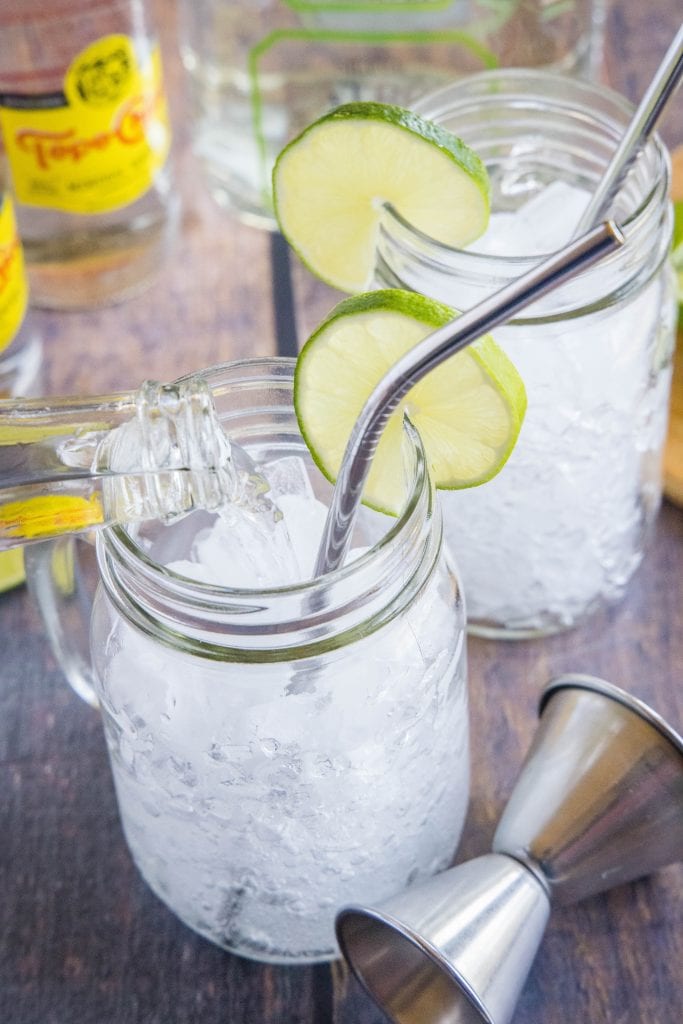 pouring topo chico into a glass