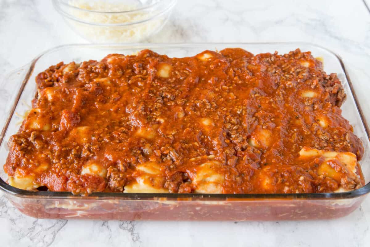 This Baked Ravioli is a quick and comforting dinner made with layers of cheesy ravioli, meaty marinara sauce, and mozzarella. It’s an easy, family-friendly meal everyone will love!