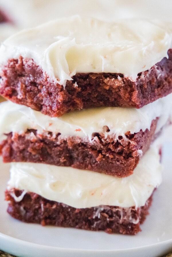 close up stack of red velvet brownies with a bite missing from one