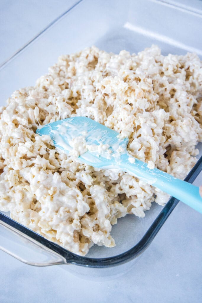 pressing cereal treats into baking dish