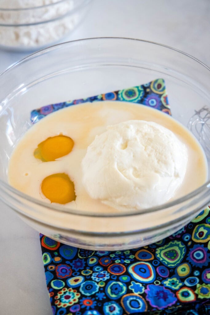 Ricotta pancake ingredients combined in a glass bowl.