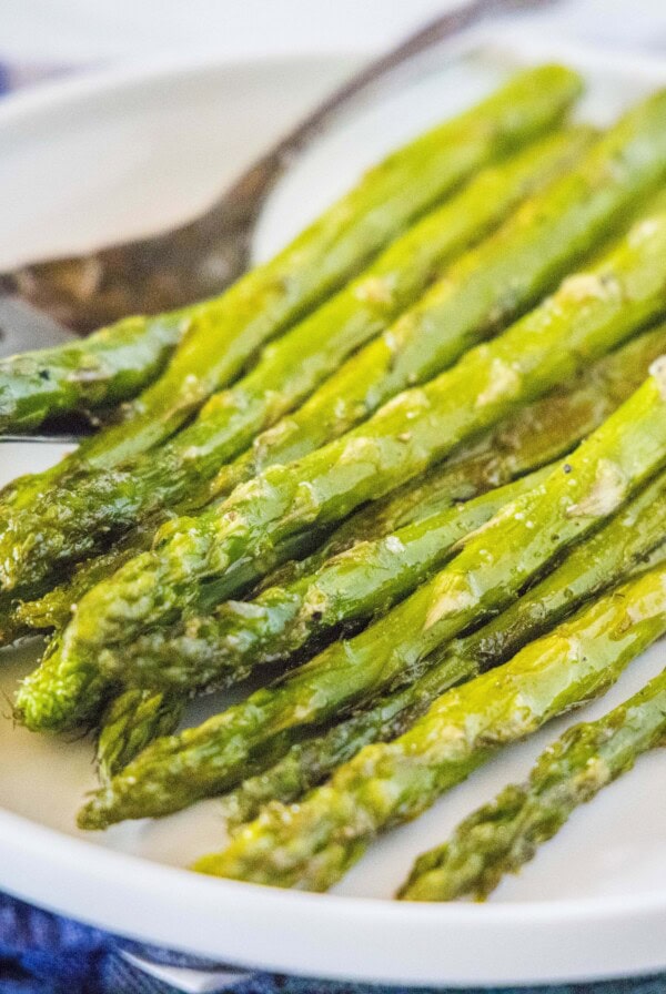 cropped image of asparagus close up on a white plate