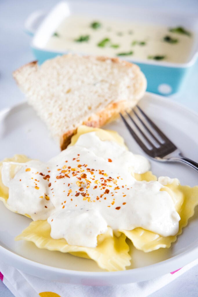 ravioli topped with roasted garlic cream sauce
