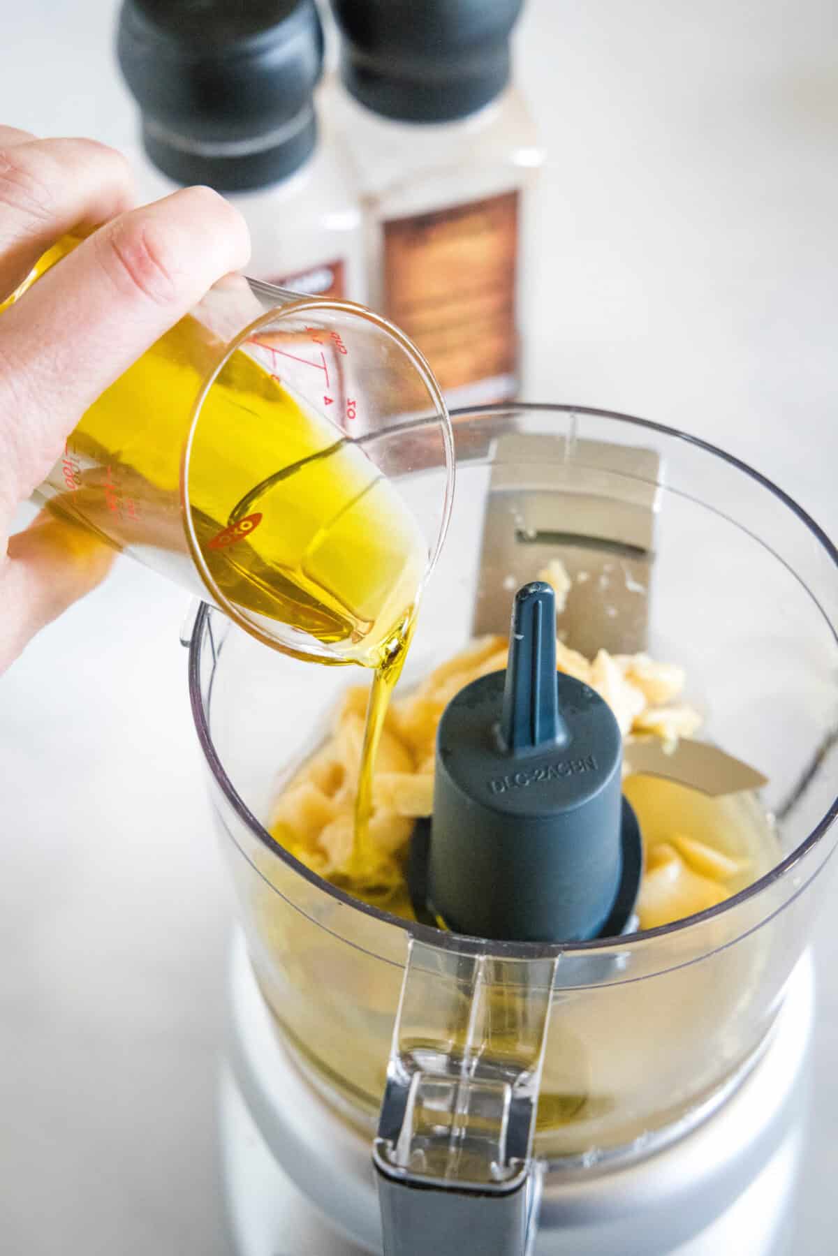 pouring oil into food processor