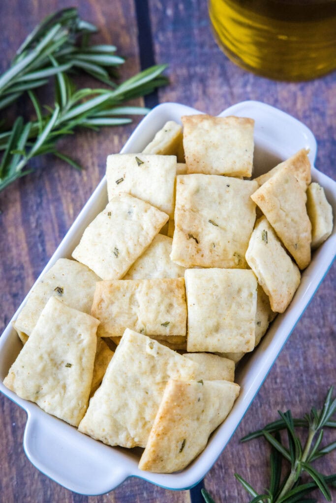 crackers in a bowl with sprigs of rosemary