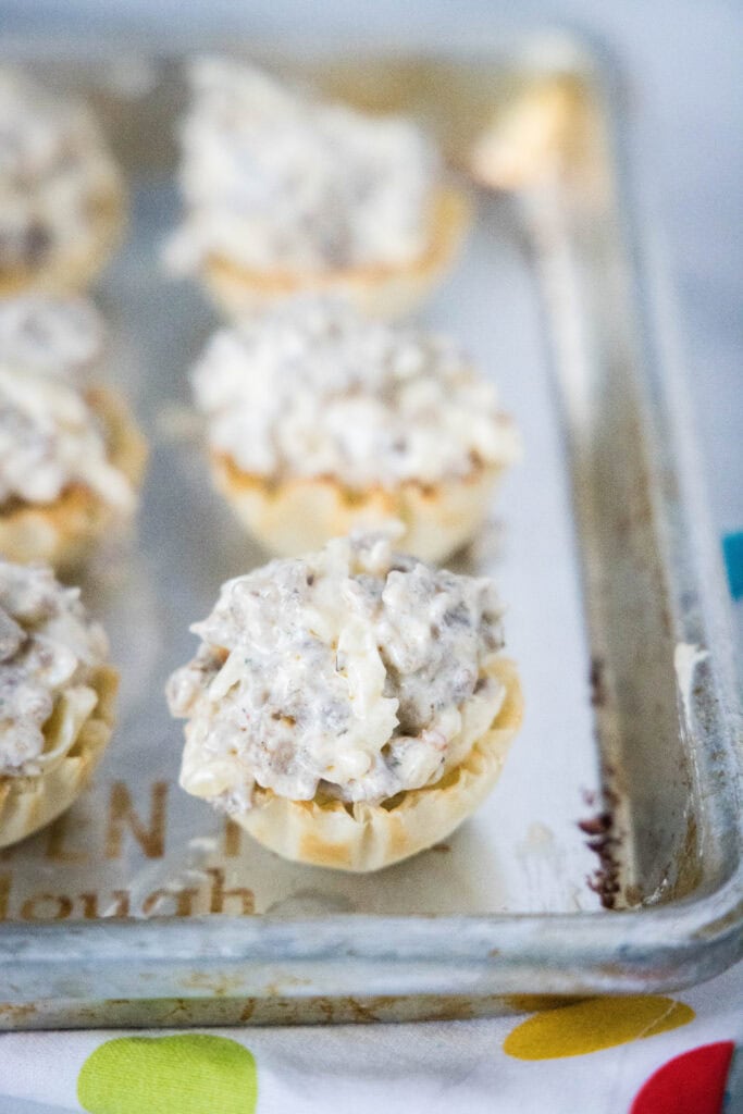 sausage cups filled and on baking tray