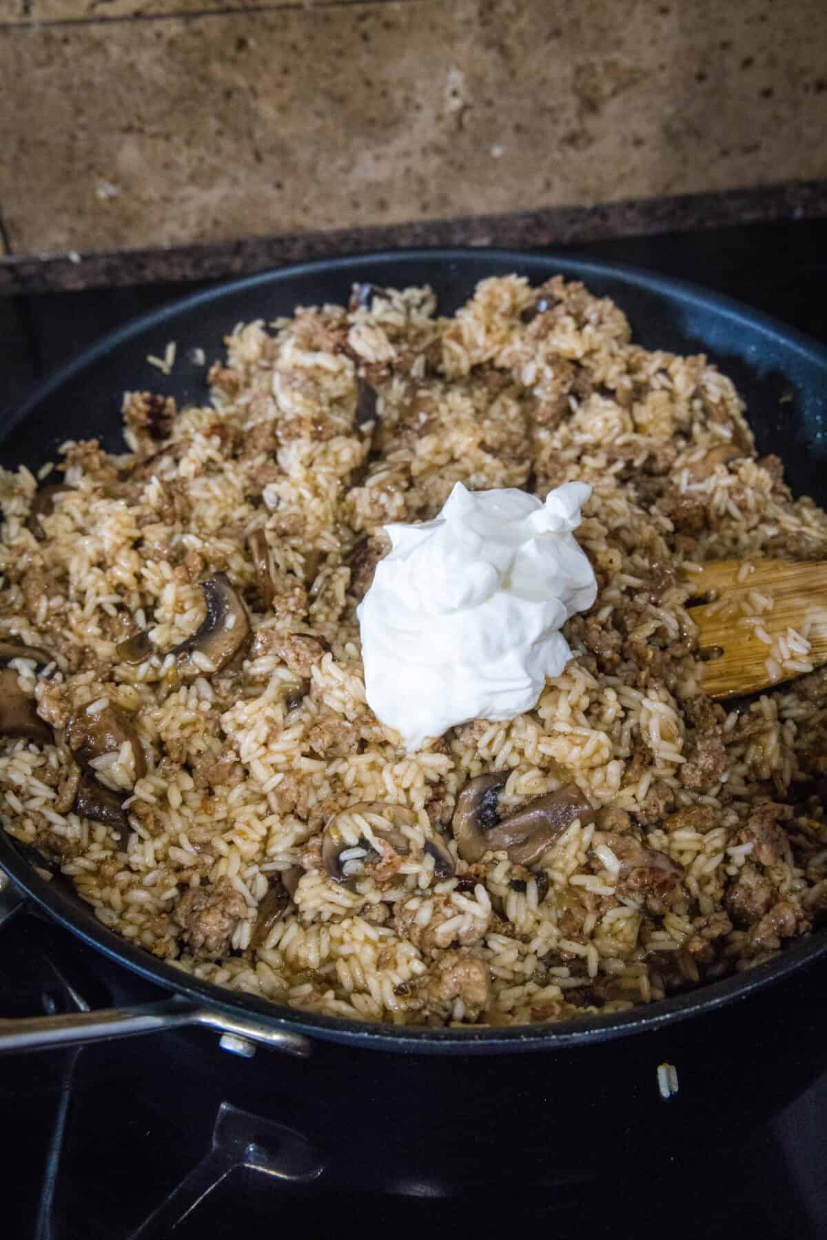 adding sour cream to rice skillet