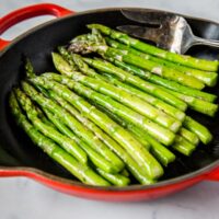 Sauteed Asparagus - super simple side dish with asparagus sauteed in butter, garlic and seasoned with salt and pepper.  Ready in just minutes, healthy, and goes with just about everything.  