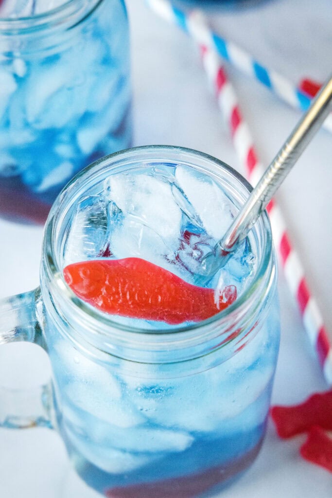 looking down on a glass of sonic ocean water with swedish fish