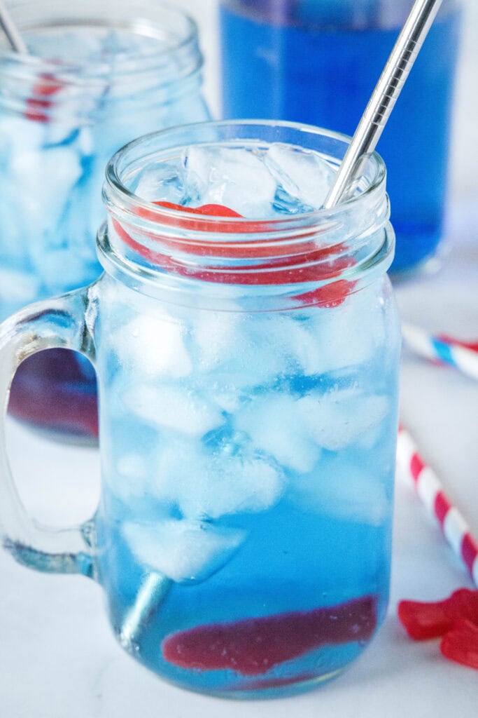 glass of sonic ocean water in a glass with straw and swedish fish