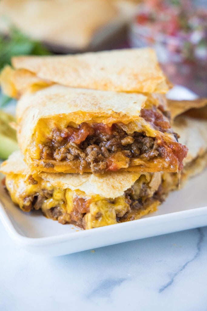 sheet tacos stacked on a plate