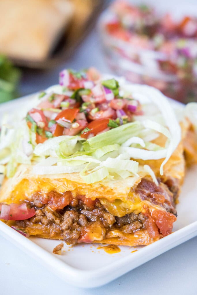 sheet pan taco slice on a plate with taco toppings