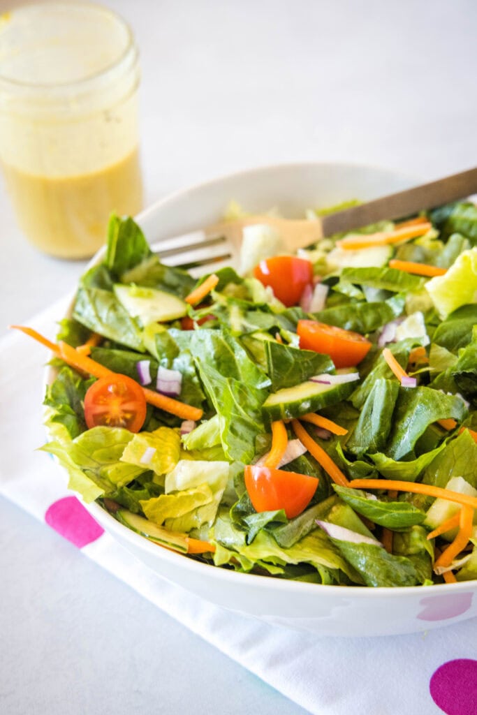 green salad mixed together in serving bowl