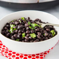 A bowl of black beans on a plate