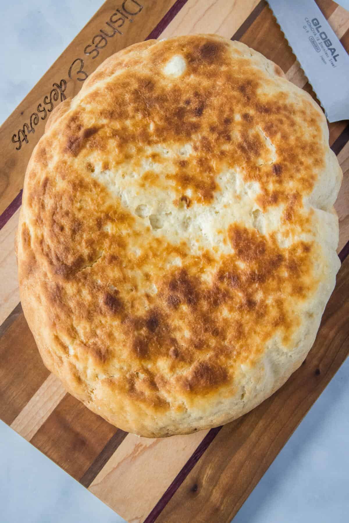 loaf of slow cooker bread on a cutting board