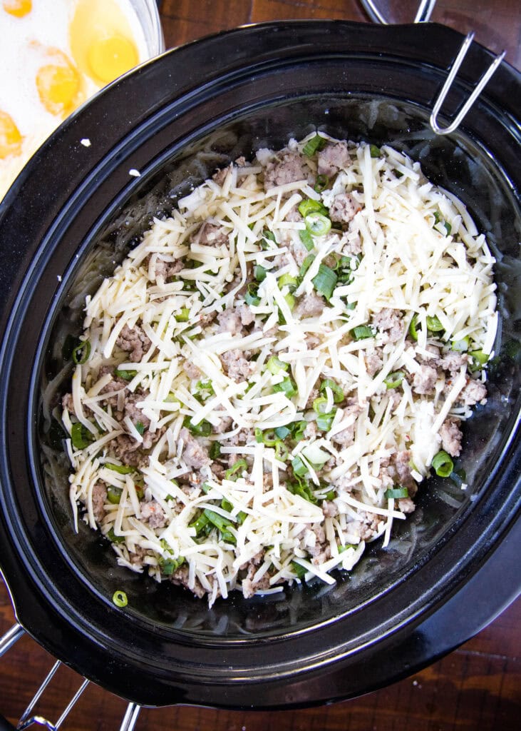 breakfast casserole in the crock pot ready for eggs
