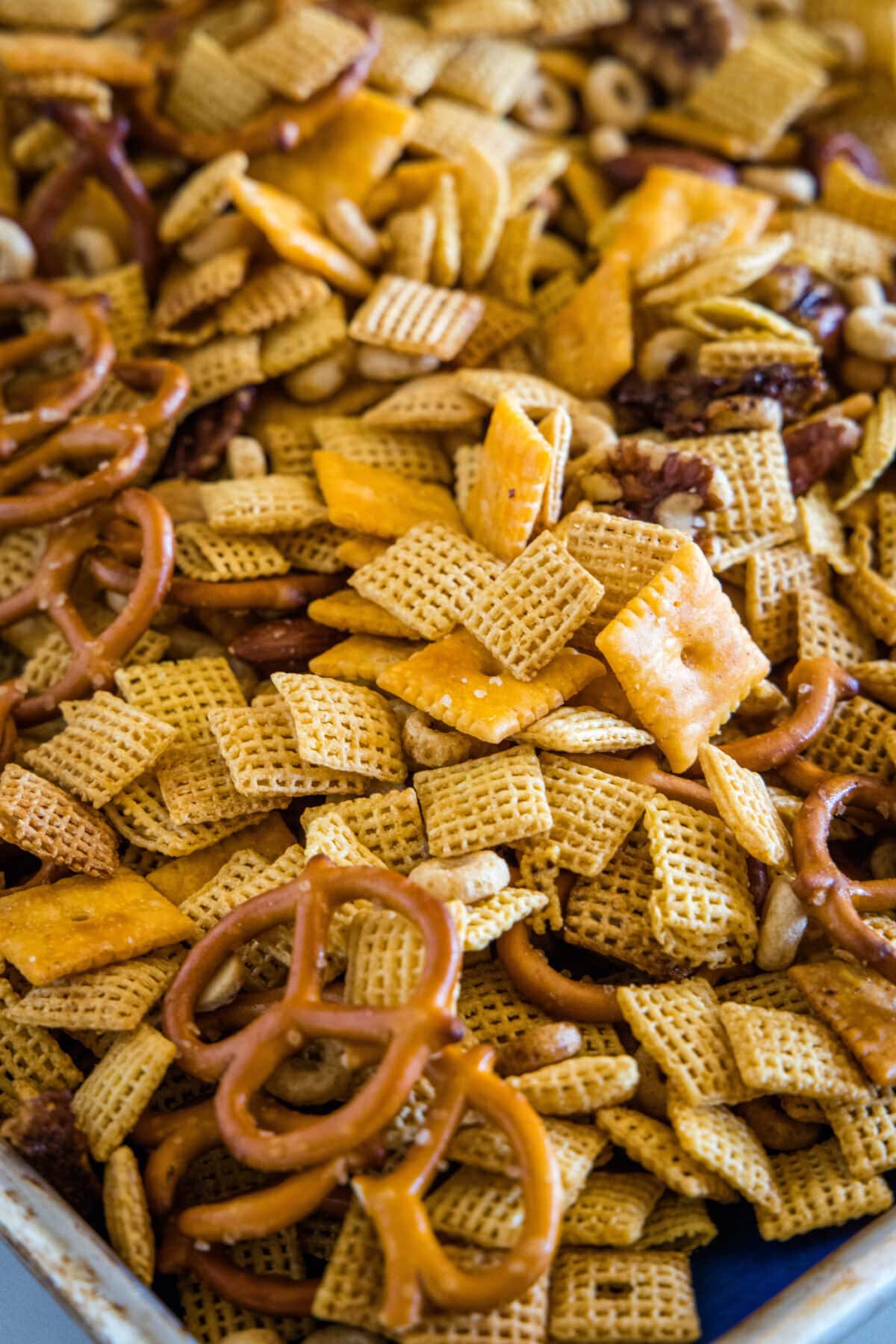chex mix cooling on a baking sheet