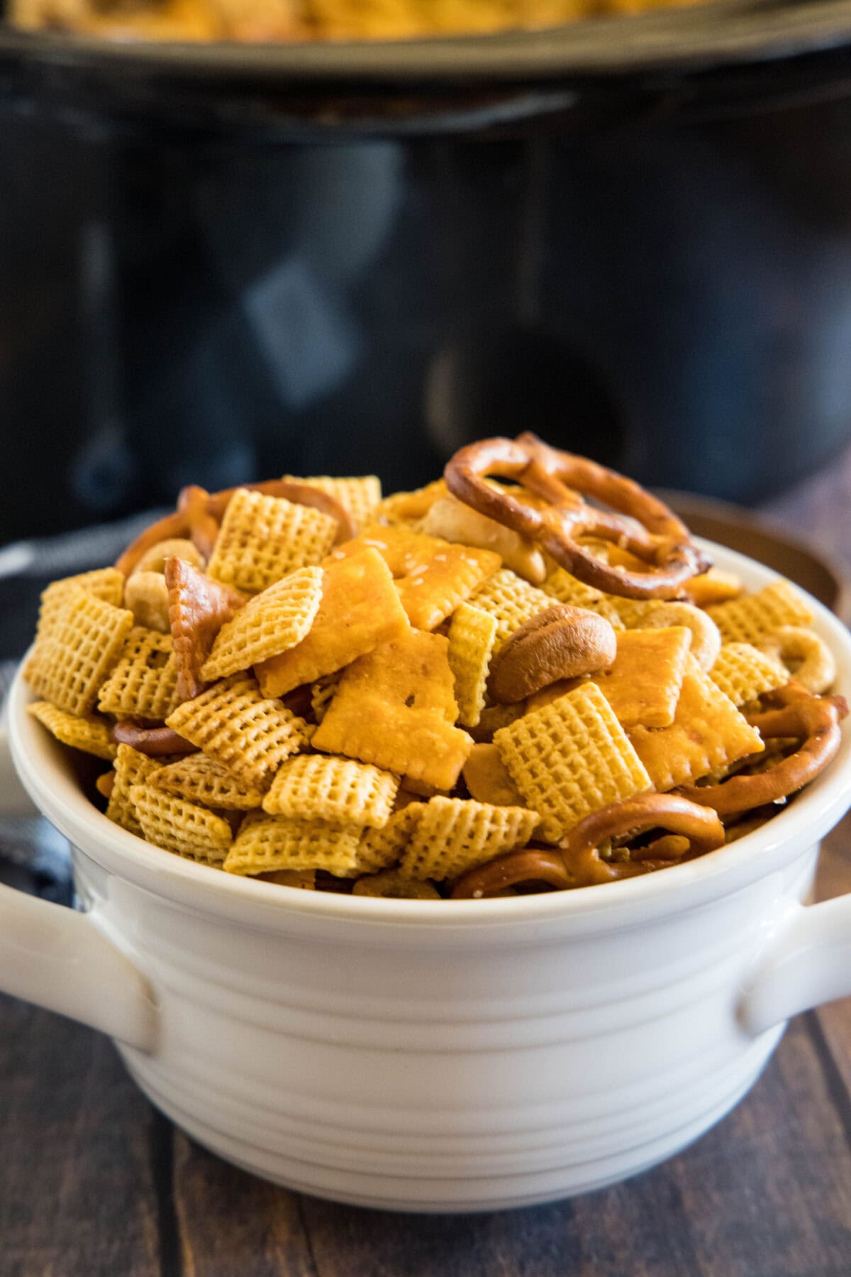 crock pot chex mix in white bowl