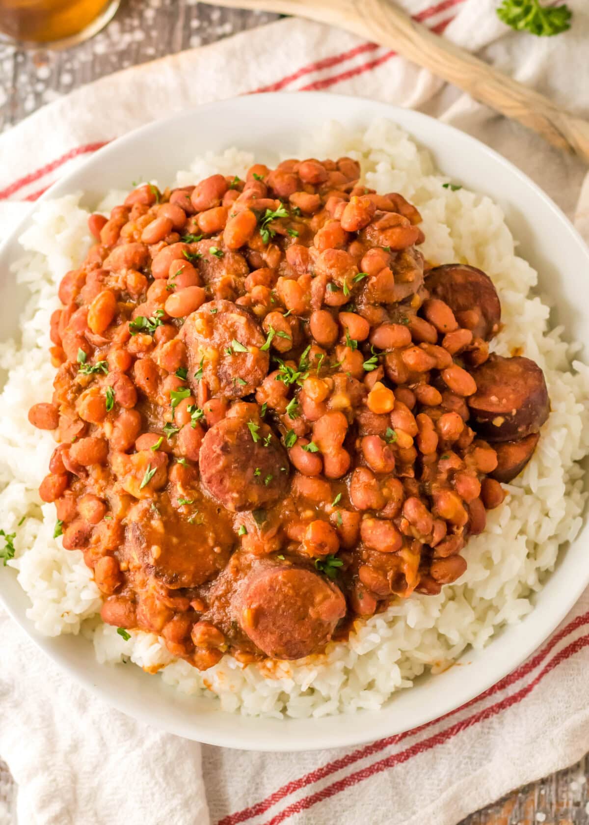 Overhead view of a plate of red beans, sausage, and rice.
