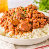View from the side of a plate of red beans and sausage on rice.