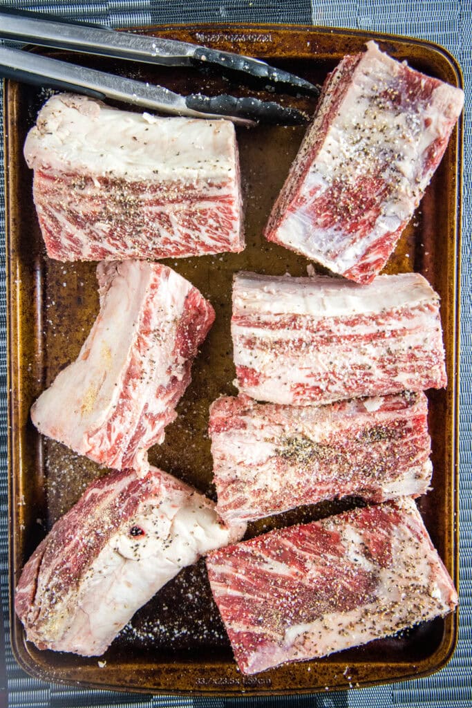seasoned beef short ribs on a baking tray