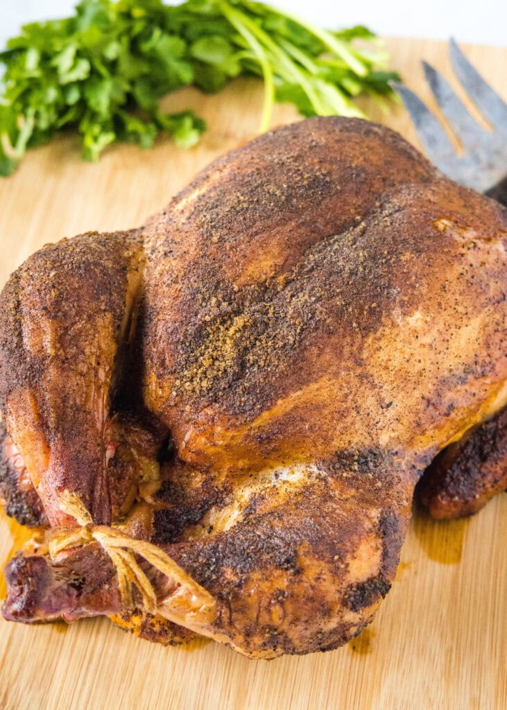 whole smoked chicken on a cutting board