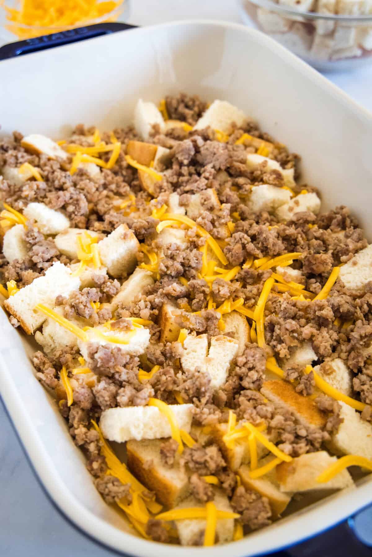 Sourdough breakfast casserole ingredients assembled in a baking dish.