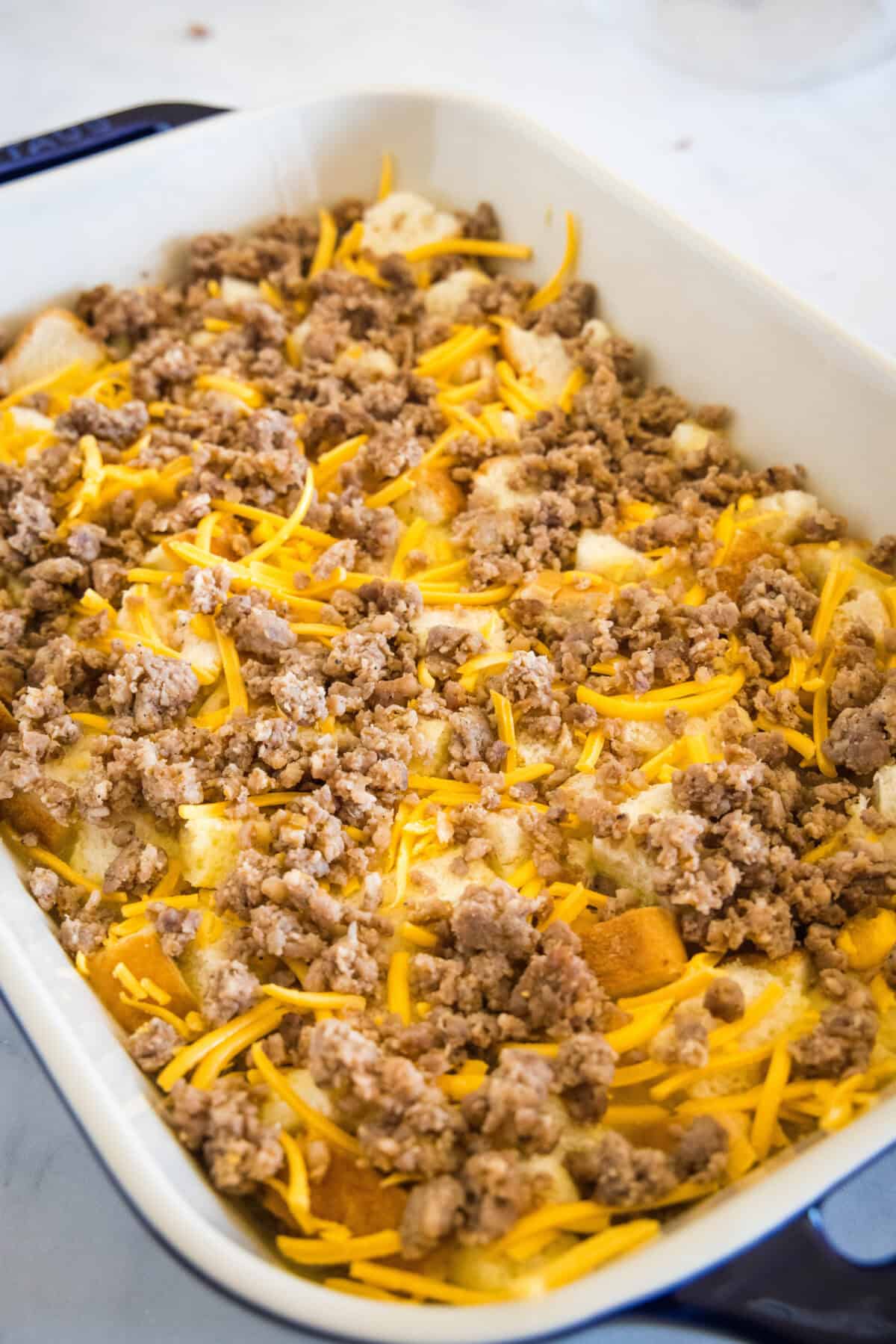 Assembled breakfast casserole in a baking dish.