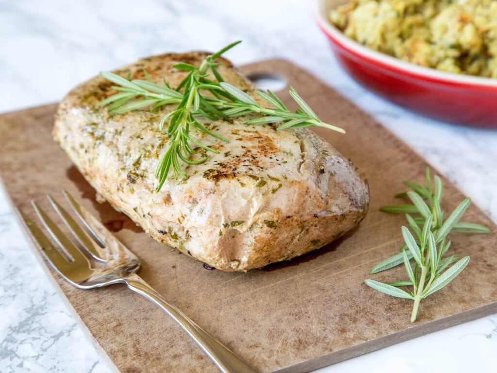 whole pork loin cooked on a cutting board
