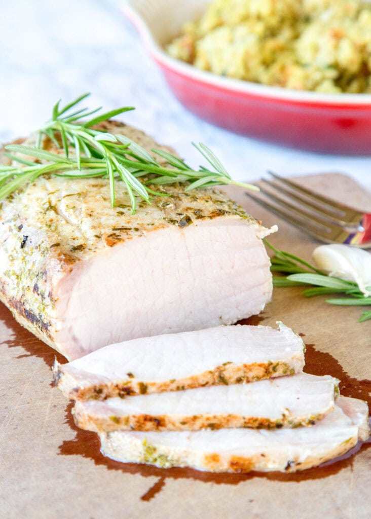 sous vide pork loin on cutting board with 3 slices